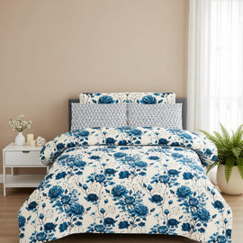 White bedsheet with large blue flowers and matching pillowcases.