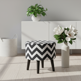 Round upholstered ottoman with a black and white chevron pattern and tapered dark legs.