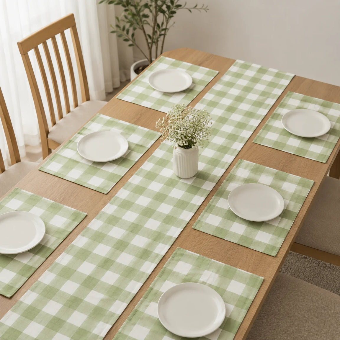 Sage green and cream checked table runner with matching placemats.