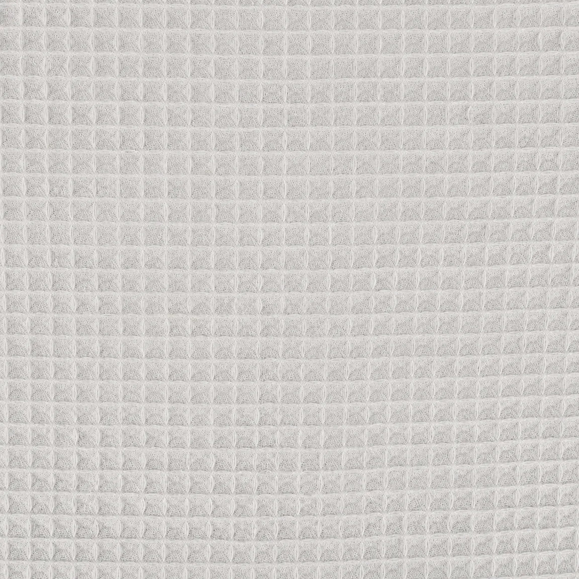 Close-up of the light grey grid texture of a cotton thermal blanket.