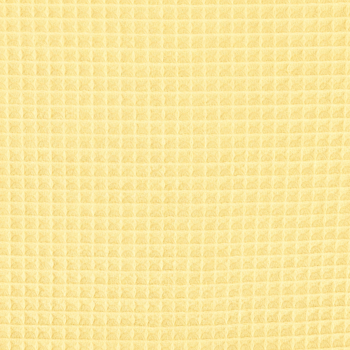 Close-up of the pale yellow grid texture of a cotton thermal blanket.