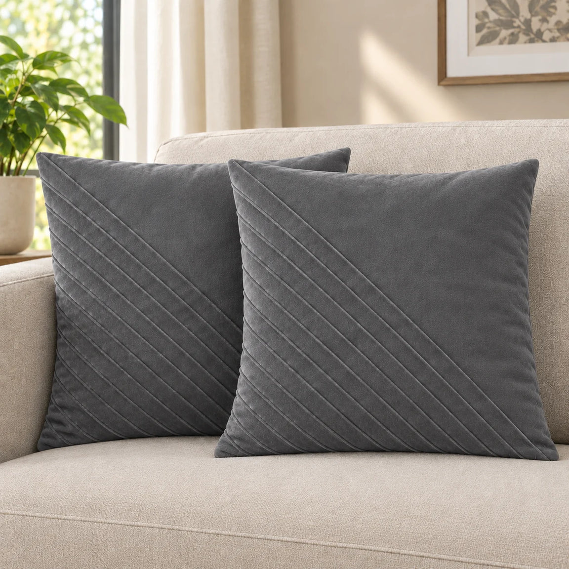 Two silver grey cushion covers with diagonal stitched lines on a cream sofa.
