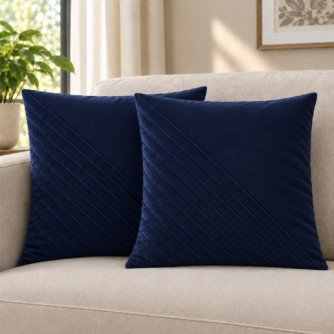 Two navy cushion covers with diagonal stitched lines on a cream sofa.