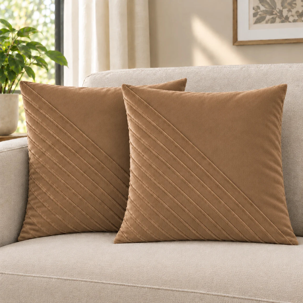 Two tan cushion covers with diagonal stitched lines on a cream sofa.
