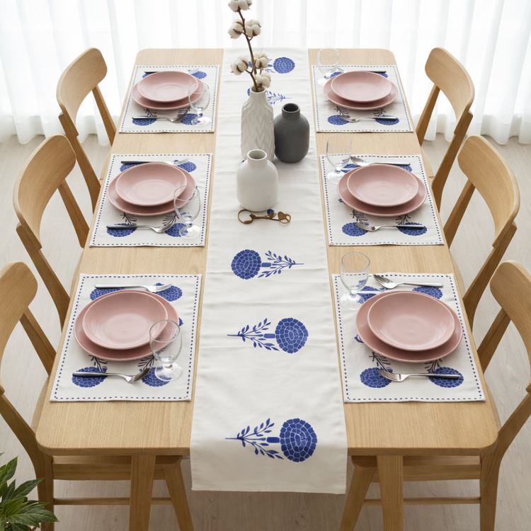 White table runner with blue stylised floral motifs and matching placemats.