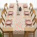 White table runner with orange botanical motifs and matching placemats.
