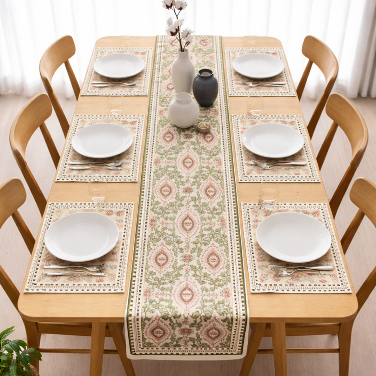 Cream floral table runner with muted pink and green motifs and matching placemats.