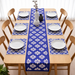 Blue table runner with white floral motifs and matching placemats.