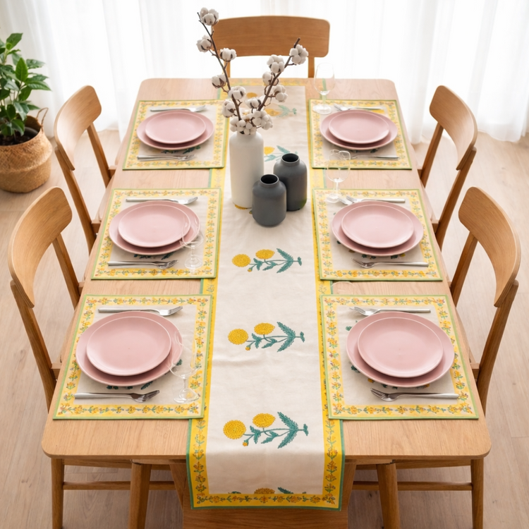 Cream table runner with yellow flowers, green leaves and matching placemats.