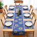 Blue table runner with green and yellow circular motifs and matching placemats.