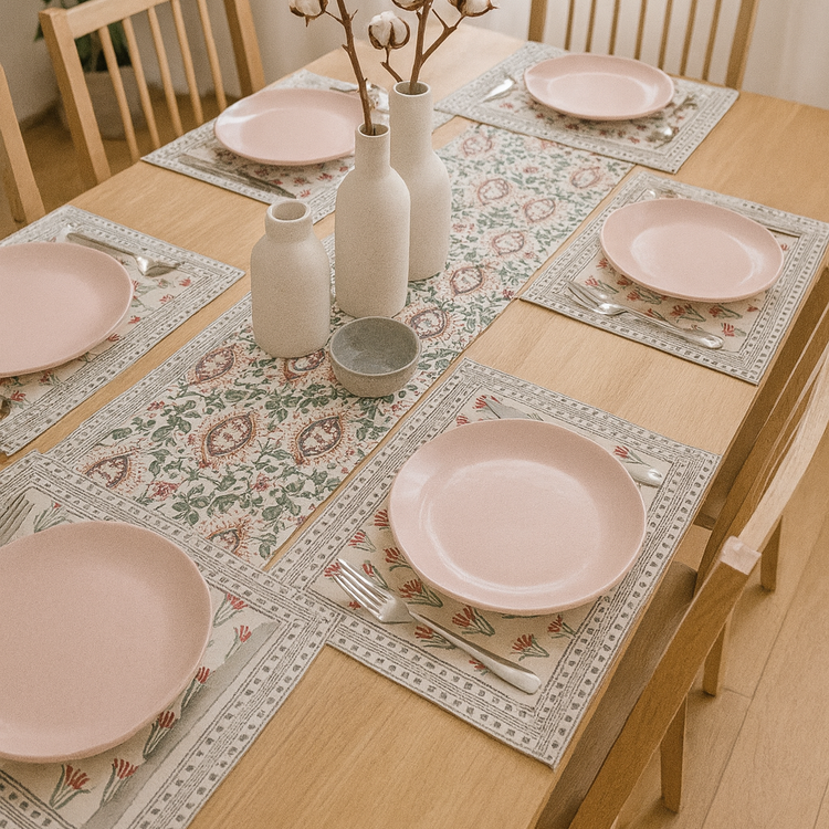 Cream floral table runner with muted pink and green motifs and matching placemats.