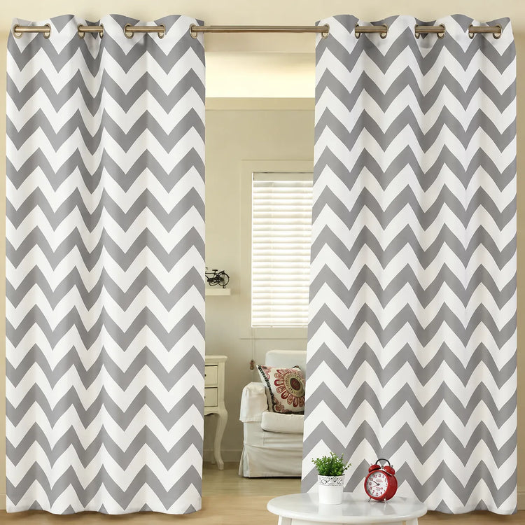 Grey and white chevron eyelet curtains hanging at a window.