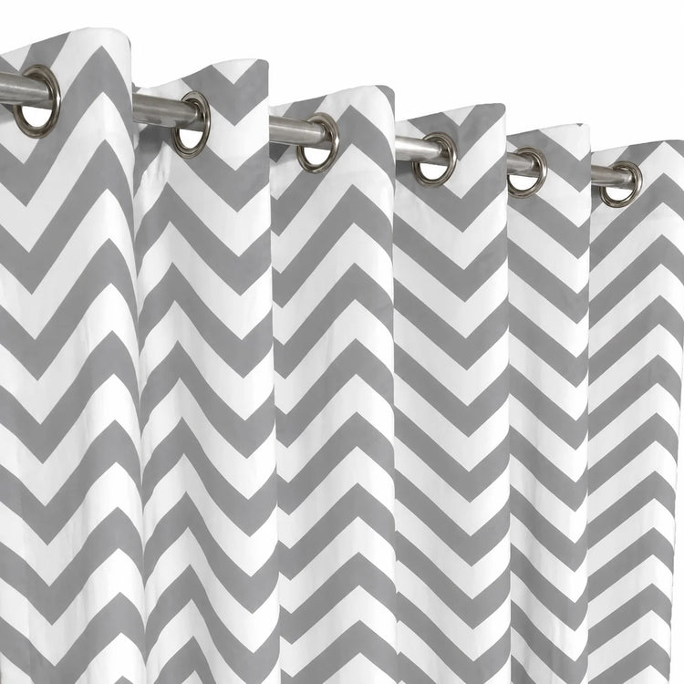 Close-up of grey and white chevron curtain fabric and metal eyelets.