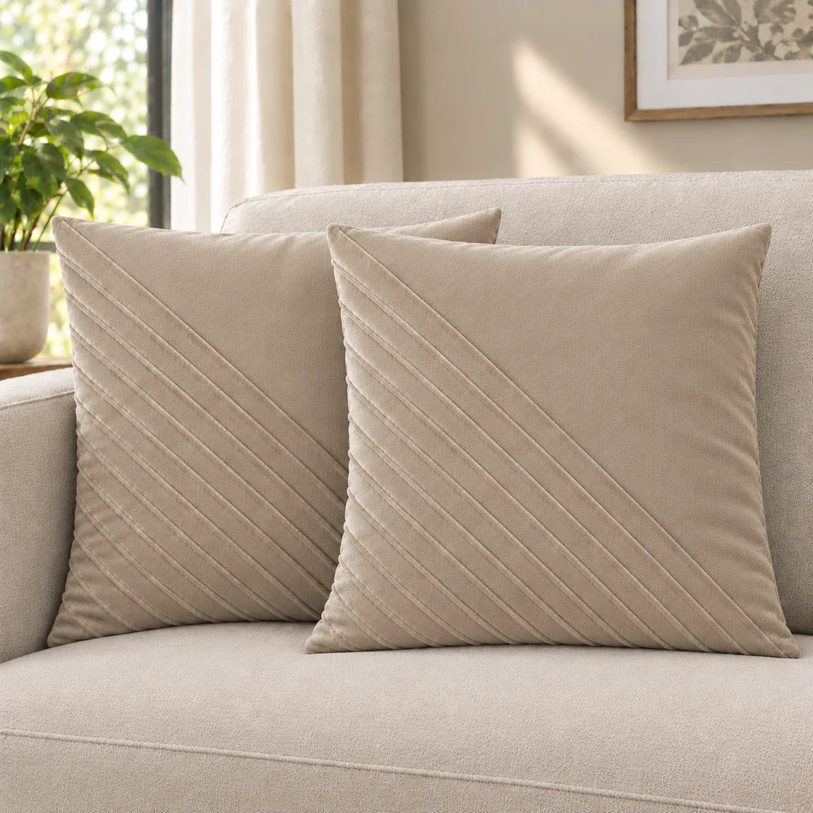 Two pale beige cushion covers with diagonal stitched lines on a cream sofa.