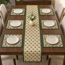 Alt Text: Wooden dining table set with white plates and cutlery, featuring a cream-colored table runner covered in a small, repeating green botanical clover pattern and solid dark green side borders.  with 6 mats 