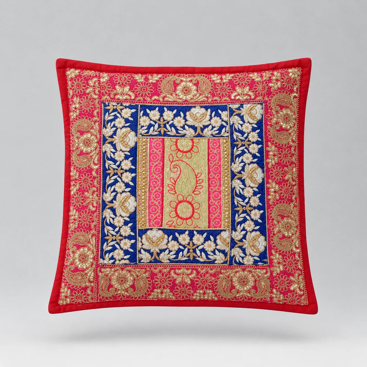 Red cushion cover with ornate gold coloured borders and a blue floral central panel.