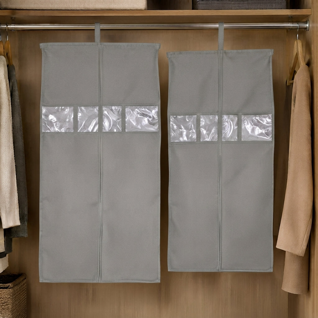 Two grey hanging garment covers with clear window panels inside a wooden wardrobe.