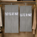 Two grey hanging garment covers with clear window panels inside a wooden wardrobe.