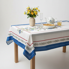 Ivory floral tablecloth with blue and red striped borders.