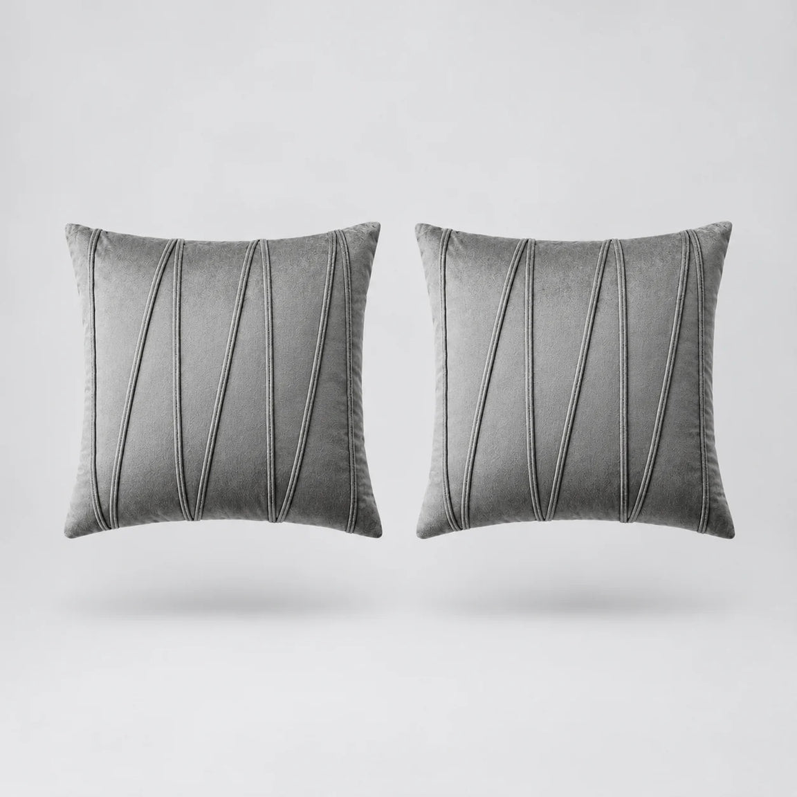 Two square gray throw pillows with vertical pleated detailing, shown side by side on a light gray background.