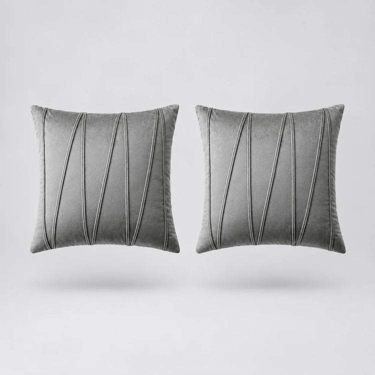 Two square gray throw pillows with vertical pleated detailing, shown side by side on a light gray background.