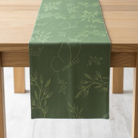 Dark green table runner with subtle botanical sprigs.