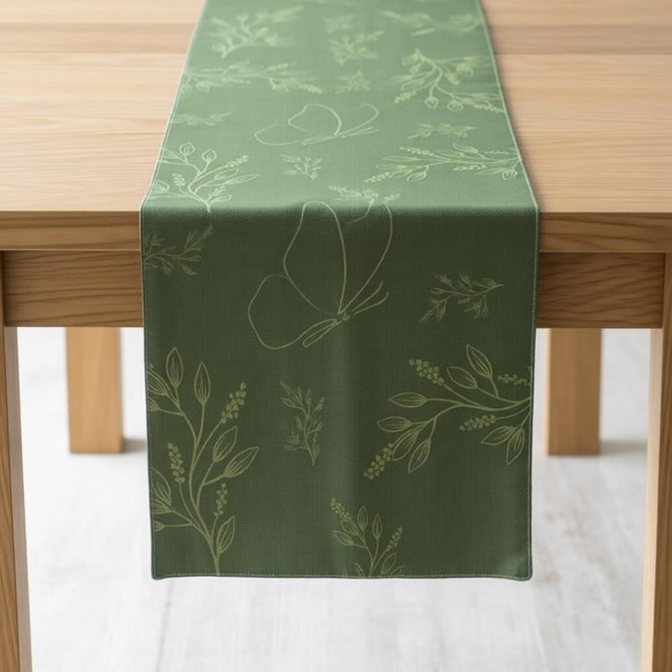 Dark green table runner with subtle botanical sprigs.