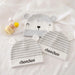 Three gray and white baby hats with bear-face and striped designs