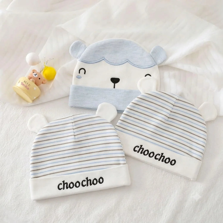 Three pale blue baby hats with bear-face and striped designs