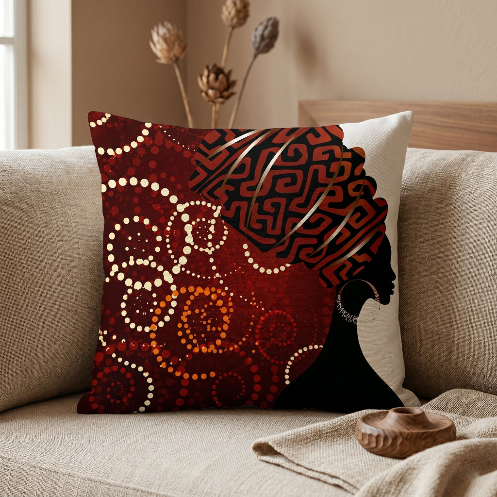 Dark red cushion cover with a black profile silhouette and an intricate red and gold coloured headwrap.
