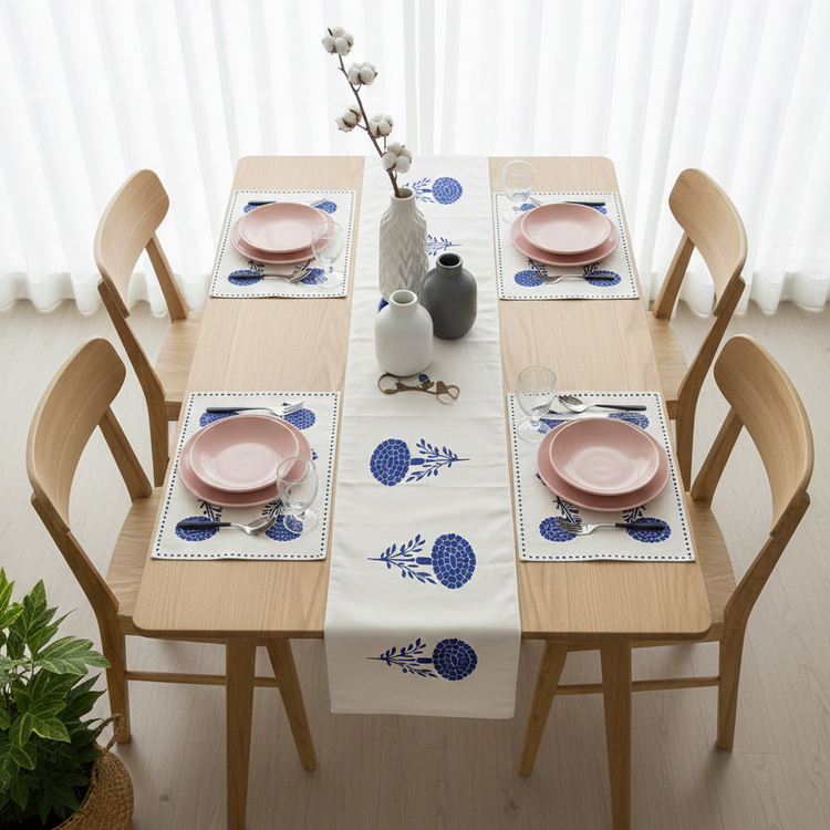 White table runner with blue stylised floral motifs and matching placemats.