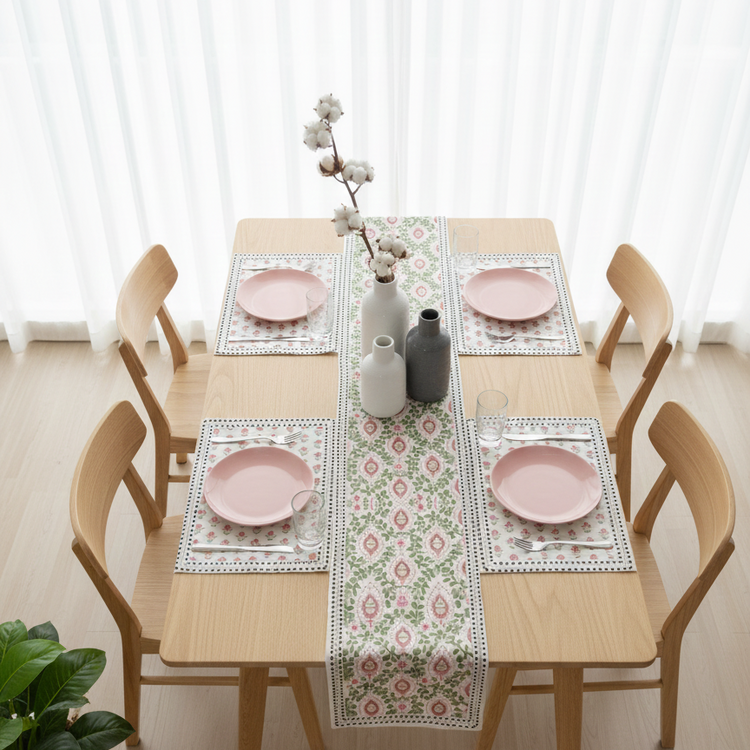 Cream floral table runner with muted pink and green motifs and matching placemats.