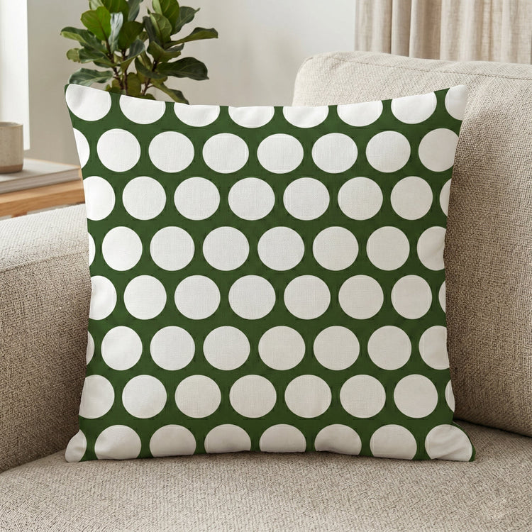 Dark green cushion cover with large white polka dots.