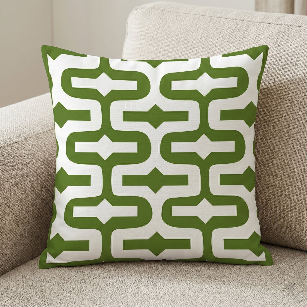 Green cushion cover with thick white interlocking geometric lines.