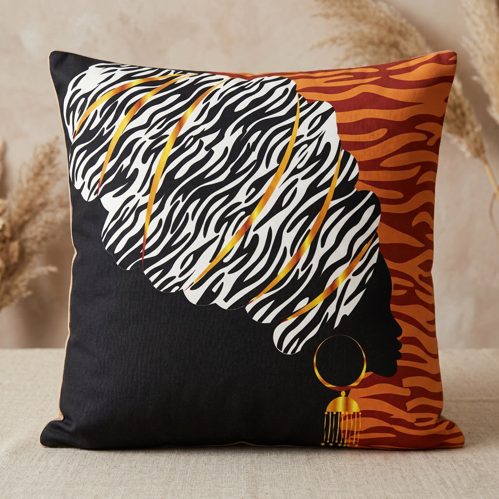 Black and orange cushion cover with a woman's profile and a large zebra-patterned headwrap.