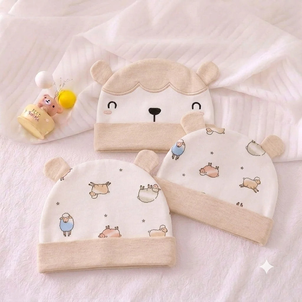 Three beige baby hats with bear-face and small animal-print designs