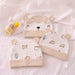 Three beige baby hats with bear-face and small animal-print designs