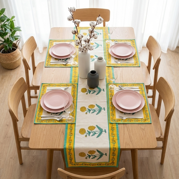 Cream table runner with yellow flowers, green leaves and matching placemats.