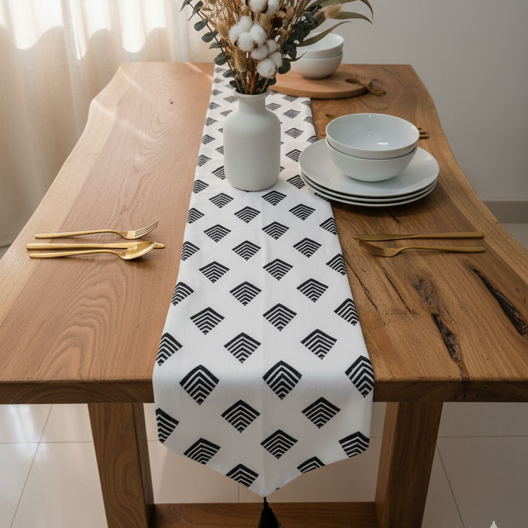 White table runner with repeating black diamond motifs.
