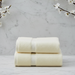 Two folded cream plain towels stacked together.