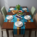 Turquoise and mustard striped table runner with matching placemats.