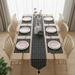 Black grid-pattern table runner with matching placemats and a tasselled end.