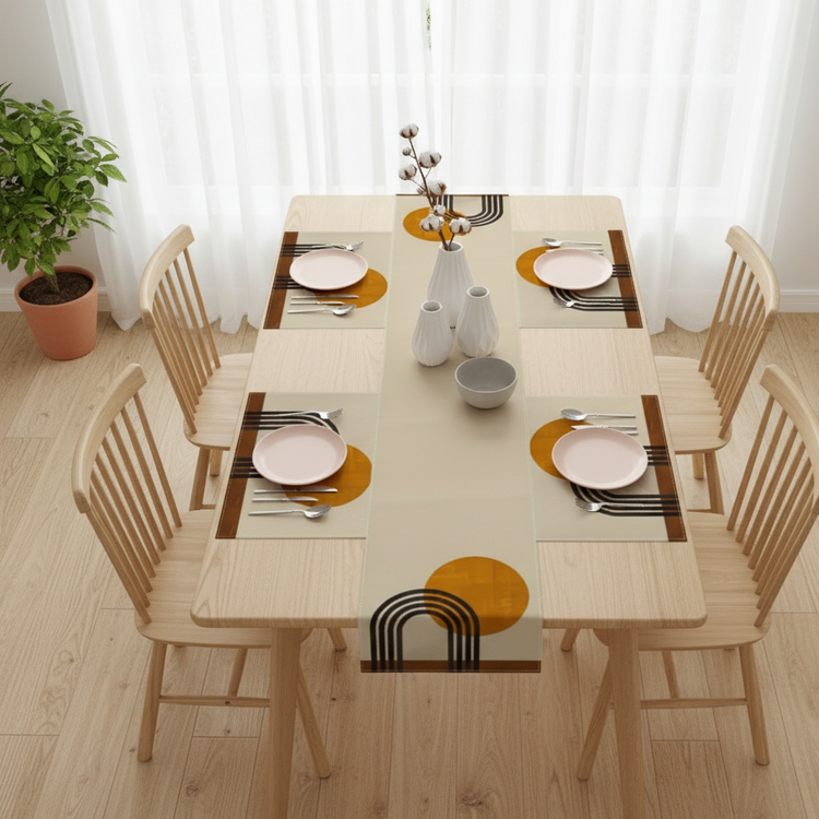 Cream table runner with mustard circles, black arches and matching placemats.