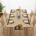 Cream table runner with mustard circles, black arches and matching placemats.