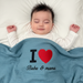 Infant under a blue waffle-textured blanket with a red heart and Baba & mama lettering