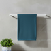Dark teal bath towel draped over a towel rail.