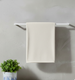 Cream bath towel draped over a towel rail.
