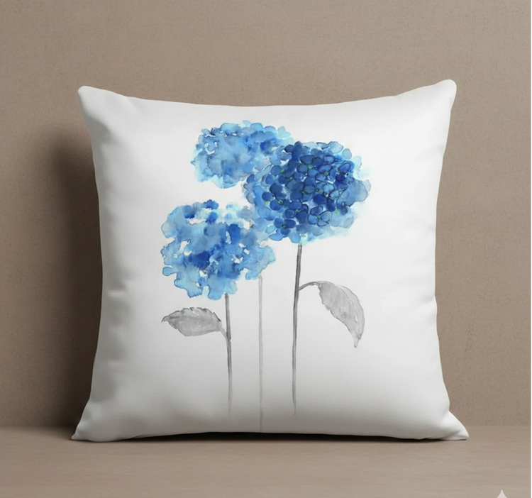 White cushion cover with two blue flower heads on slender grey stems.