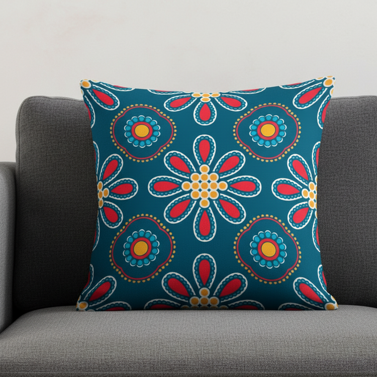 Navy cushion cover with colourful circular flowers and petal motifs on a grey sofa.
