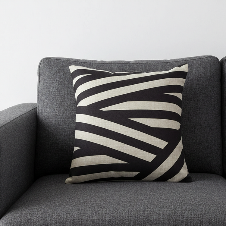 Cushion cover with sweeping black and cream diagonal stripes.